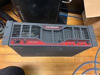 Front view of Crown CE1000 front panel showing rack ears, power switch, gain knobs, vents