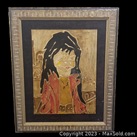 Frontal view of the framed original artwork featuring a stylized portrait and earthy tones.