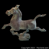 Left side view of bronze horse galloping with base bird detail