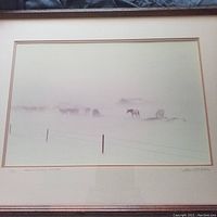Framed lithograph showing the full art and mat with the herd of horses in a snow blizzard scene.