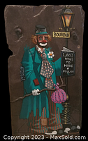 Full view of hand painted clown artwork on slate, showing clown in teal coat with lamp post and book