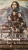 Close-up photo showing central characters and title on the vinyl poster.