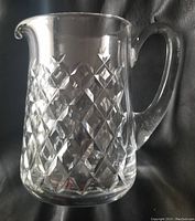 Front view of Waterford crystal pitcher showing the cross-hatch diamond cut pattern and clear handle.