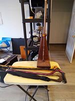 Photo showing the wooden pyramid shaped cane holder with six canes laid on the table