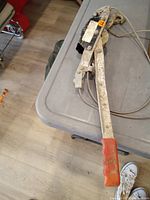 Full view of come along with cable and red handle