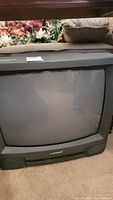 Front view of the 20 inch Magnavox CRT television, showing the curved screen and black plastic frame with Magnavox branding.