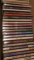 Stack of CD spines with multiple music albums, mostly jazz, rock, classical, and country genres visible.