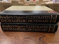 Two volumes of Reader's Digest Illustrated Encyclopedic Dictionary, spines marked A-K and L-Z.