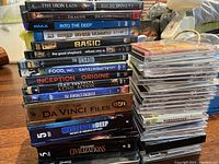 Stack of DVDs showing movie and documentary titles including The Iron Lady, Red Dragon, Into the Deep, Inception, and others.