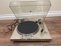 Full view of Sony PS-T20 stereo turntable with dust cover open, showing platter, tonearm, and cables.