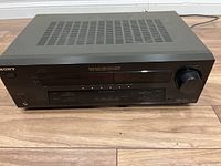 Front angle view of Sony STR-DE595 Surround Receiver showing the overall unit and front control panel.