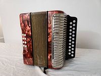 Angled front view showing left-hand bass buttons and right-hand grille