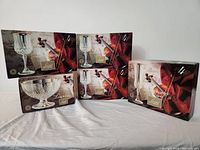 Five original boxes of Longchamp Gold Cristal d'Arques glassware, featuring 12 goblets, 4 flutes, and 1 stemmed bowl.