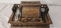 Jewelry box top view with two wristwatches and two bracelets on top