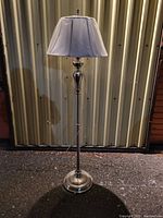 Full view of the Kichler floor lamp showing the complete lamp with metallic base and wrapped white lampshade.