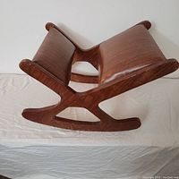 Wooden posture corrector kneeling chair lying on side showing wood frame and knee pad cushions