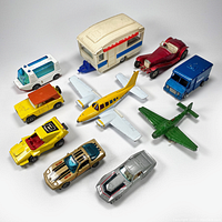 All 10 assorted diecast toys including cars, planes, and one camper trailer displayed on a white background.