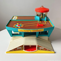 Front angle of the vintage playset base showing control tower with pilot figure and helicopter crank, airport decal details including baggage claim areas and flower decals near base edges.