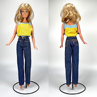 Front and back view of full 11.5 inch female doll wearing yellow sleeveless textured top and blue denim Jordache jeans, no shoes, on a doll stand.