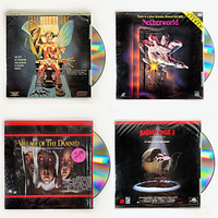 Four vintage horror movie laserdiscs, each with distinct cover art and visible laserdiscs in plastic sleeves.