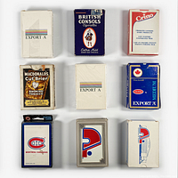 Nine vintage playing card decks arranged in a 3x3 grid on a white surface. The decks show branding from Export A, British Consols, Crimo Dairy Products, MacDonald's Cut Briers, Montreal Canadiens, and Quebec Nordiques. Some decks are sealed in plastic.