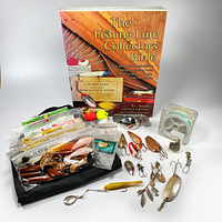 Overview of the fishing lot showing the collectible book, various lures in zippered pouch, bobbers, and tackle items on display.
