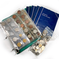 Photo showing binder with coin pages filled with various foreign coins, 4 blue Canadian coin collecting books, and a bag of loose coins