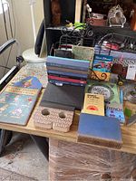 Books and book stand arranged on a table, showing various titles and the bookshelf items
