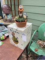 Photo showing the fountain placed on its original box on an outdoor table, with the full set visible including the box featuring Japanese text and Totoro graphics.