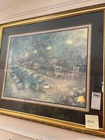 Photo of full framed print showing the garden scene with two chairs and pond, including tags and price sticker visible.