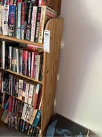 Side and partial front view of the wooden bookshelf demonstrating the natural wood grain and shelf spacing.