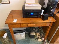 Full view of wooden desk with printer on top, showing overall condition and drawer details.