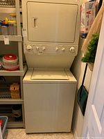 Front view of stacked washer and dryer in closet