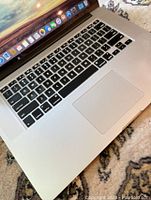 Angle view of keyboard and trackpad with macOS dock visible