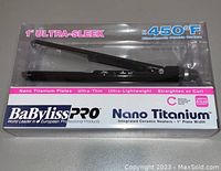 Front boxed view of BaBylissPRO 1 inch Nano Titanium hair straightener highlighting features such as ultra-sleek design, 450°F temperature, and nano titanium plates.