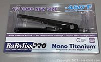 Front view of sealed BaByliss Pro hair straightener packaging showing product and branding, emphasizing 1¼ inch plates, nano titanium technology, and maximum heat of 450°F.