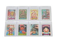 Fronts of eight Garbage Pail Kids cards in protective sleeves, displaying characters and names