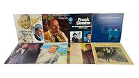 Full view of 9 assorted vinyl LP albums arranged showing cover art and artists.