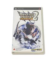 Front cover of Monster Hunter Freedom 2 PSP game case showing logo, monster, hunter, and Capcom branding.