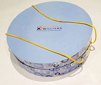 Round Maxwell Williams box with outer retro pattern and yellow cord