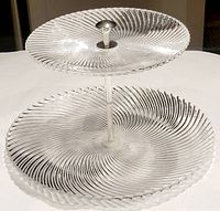 Full view of 2-tier Nachtmann swirl pattern glass tray showing both tiers and metal handle.