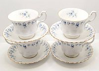 Four Royal Albert Memory Lane teacups each paired with a matching saucer, showing front and top views