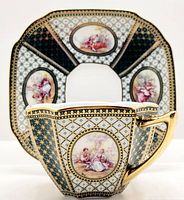 Side view of squared cup showing painted classical portraits and gold handle with matching saucer background