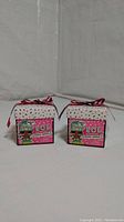 Front view of the two LOL Surprise boxes showing the cartoon doll images and pink polka dot design.