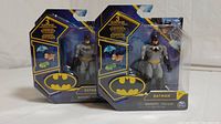 Two Batman mini figures in original packaging, front view showing figure and accessories.