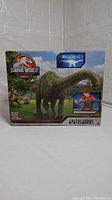 Front view of Jurassic World Legacy Collection Apatosaurus dinosaur toy box showing branding, dinosaur image, size, and child illustration.