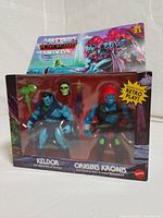 Front view of boxed Keldor and Kronis Masters of the Universe action figure set, showing figures, weapons, and packaging artwork.
