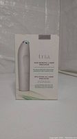 Front view of the Tria Hair Removal Precision Laser box showing device image and branding.