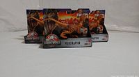 Six Jurassic World Legacy Collection Velociraptor figures in original packaging grouped together