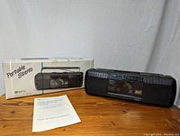 Full view of GPX Model C815 boombox alongside its original box and manual, showing overall condition and packaging.